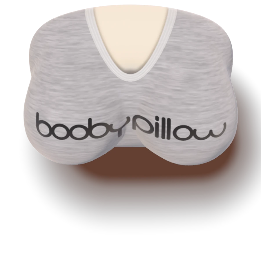 The Booby Pillow in the grey logo tee cover, lying on a bed